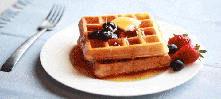 GIF of syrup being poured on a stack of 2 waffles.