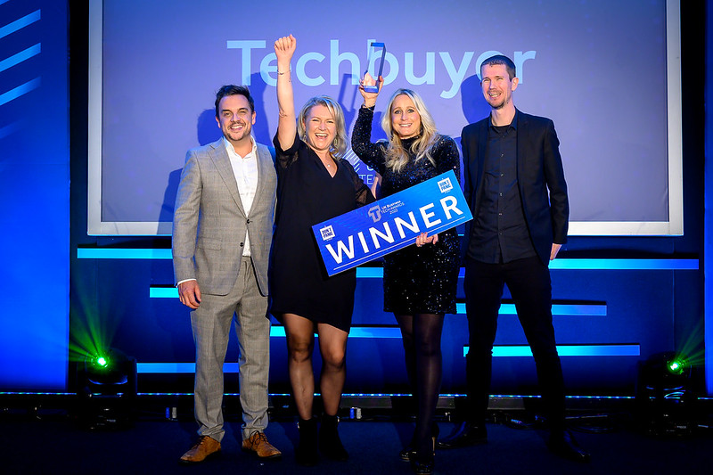 Winners of the UK Business Tech Awards standing on the stage, celebrating
